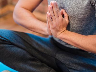 Focus on hands in a prayer position for balance